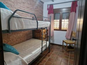 A bed or beds in a room at Aptos El Manantial Burunchel