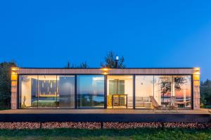 a house with large windows and a table and chairs at VyriY House in Lis