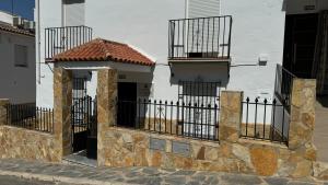 a building with a gate and balconies on it at El soberano in El Gastor
