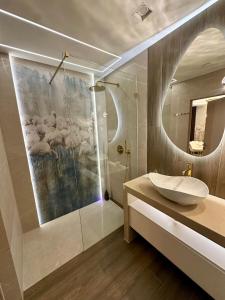 a bathroom with a sink and a mirror at Masarska 8 VIP Apartamenty JACUZZI in Kraków