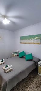 a bedroom with a large bed with green pillows at HolaMar in Benicarló +50 photos