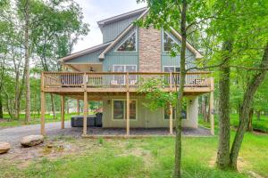 a house with a wrap around deck in the woods at Forest Views and Hot Tub Poconos Cozy Cabin in Albrightsville