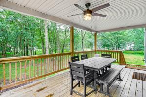 a screened porch with a table and chairs at Lake Access and Hot Tub Forest-View Poconos Cabin in Albrightsville