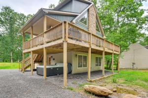 a large house with a deck and a tub at Lake Access and Hot Tub Forest-View Poconos Cabin in Albrightsville