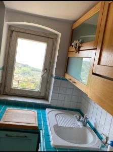 een badkamer met een wastafel en een raam bij LA FINESTRA SUL MARE in Camogli