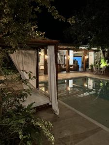 a house with a swimming pool at night at casa lumka hotel boutique spa in Mariquita