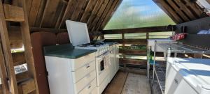 a kitchen with a stove and a sink in a house at B&B Casa Arcangeli in Bracca