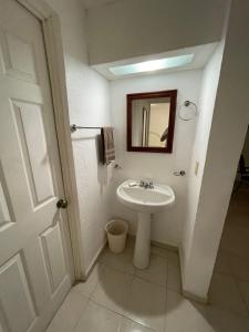 a bathroom with a sink and a mirror at Departamento céntrico Huatulco in Santa Cruz Huatulco +13 photos