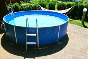 a large blue pool with two chairs in it at Chalupa Radovanka in Jičín