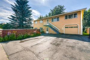 a large house with a fence and a driveway at Cozy Apartment Less Than 4 Miles to Downtown Anchorage! in Anchorage