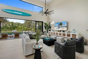 a living room filled with furniture and a large window at Casa Ola Aloha in Playa Avellana