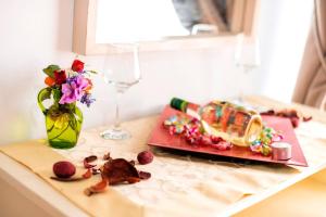 a table with a plate of food and a wine glass at Garden Studios N3 in Archangelos