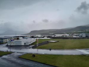 a view of a parking lot with mountains in the background at Guesthouse in Ólafsvík