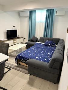 a living room with a bed and a couch at Apartma Hany in Koper