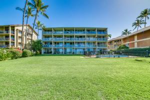 a large building with a lawn in front of it at Beachside Kihei Vacation Rental with Stunning Views! in Kihei