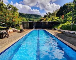 a swimming pool with blue water at Eco Flat Pedra do Rodeadouro Hotel Fazenda in Bonito