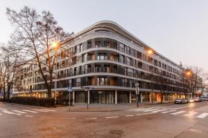 a large building on a city street at dusk at Masarska 8 VIP Apartamenty JACUZZI in Kraków