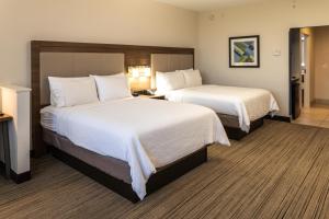 a hotel room with two beds with white sheets at Holiday Inn Express - Grand Island by IHG in Niagara Falls