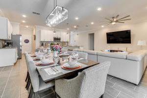 a dining room and kitchen with a table and chairs at Relax, Play, Swim Luxe Haines City Home with Lanai! in Haines City