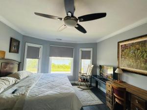 a bedroom with a bed and a ceiling fan at Waterfront Home Windsor ,On, Ca in Windsor