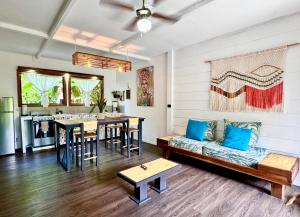 a living room with a couch and a table at Chilamate Holiday House in Puerto Viejo