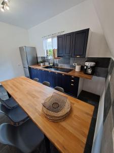 a kitchen with a wooden table with a hat on it at Cabană A-Frame Bran Chalet in Sohodol +99 photos