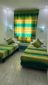 Postel nebo postele na pokoji v ubytování Hôtel Etoile de Mer