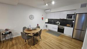 a kitchen with a table and chairs in a room at Magnólia Residence in Funchal