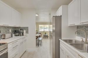 a kitchen with white cabinets and a sink at Miami Gardens Apt 5 Miles to Hard Rock Stadium in Miami Gardens