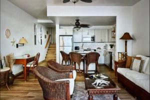 a living room with a couch and a table at Luxury Beachfront Apartments Grace Bay Beach in The Bight Settlements