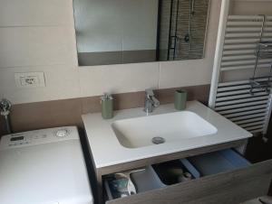 Un baño con un lavabo blanco y un espejo. en Vince & Rita's home, en Sestri Levante 36 fotos más