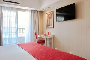 TV a/nebo společenská místnost v ubytování Ramada by Wyndham Buenos Aires Centro