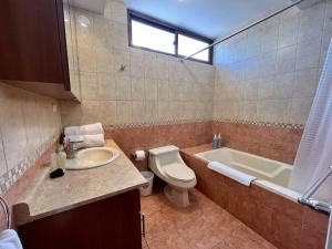 a bathroom with a toilet and a sink and a tub at DP4 Spacious apartment, great views of the city in Guatemala +13 photos