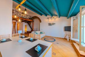 a living room with a blue ceiling and a couch at ALBACHIARA by CefaLux in Cefalù