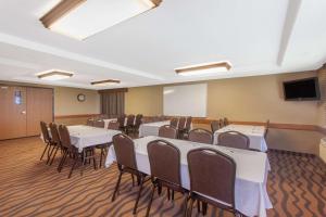 a conference room with tables and chairs and a tv at AmericInn by Wyndham St Cloud MN I-94 in Saint Cloud +40 photos