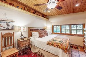 a bedroom with a bed and a ceiling fan at Casa Raya Taos in Taos