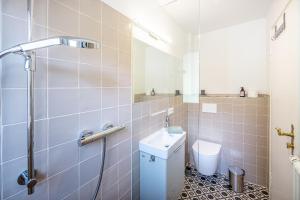 a bathroom with a toilet and a sink and a shower at Haus am Rebberg in Öhningen