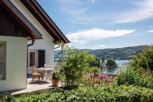 a house with a balcony with a view of a lake at Haus am Rebberg in Öhningen