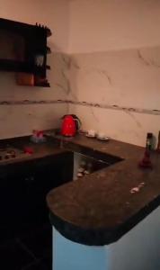a kitchen with a marble counter top and a counter top at it is a calm place in Ghazoua