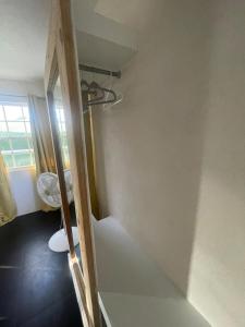 a room with a stairway with a window and a stairsuggestuggestuggestuggest at Scarlett Studios 1 -US Embassy Appt 7 mins drive- Lloyd Erskine Sandiford Centre and Ross uni 5 mins drive - Only the 1 night package includes Airport and US Embassy roundtrip in Bridgetown +10 photos