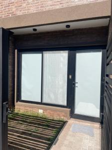 a garage with two windows and a door at Smarthouse in Capitán Bermúdez