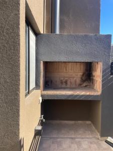 a brick oven in the side of a building at Smarthouse in Capitán Bermúdez