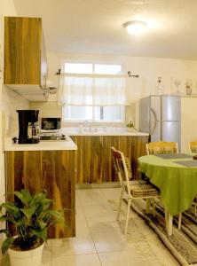 a kitchen with a table with a green table cloth at Vistas Pátzcuaro 302 in Pátzcuaro