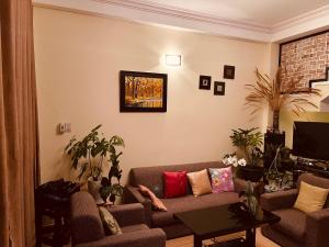 a living room with a couch and a table at BắpHouseHomestay in Da Lat