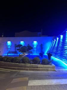 a building with blue lights on it at night at SeaHouse Villasimius in Villasimius
