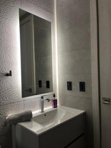 a bathroom with a white sink and a mirror at Apart studio en la mejor zona de Quito La Carolina in Quito