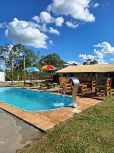 a pool with a water fountain in a yard at Chácara Império dourado in Álvares Machado