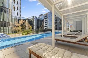 an outdoor patio with a pool in a building at Refined 2-Bed With Luxurious Building Amenities in Belconnen