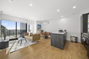 an open living room with a couch and a table at Refined 2-Bed With Luxurious Building Amenities in Belconnen