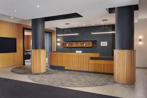 a lobby with a reception desk and a flat screen tv at Residence Inn by Marriott Calgary Airport in Calgary +32 photos